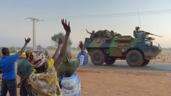Malians wave to French soldiers as a convoy of armored vehicles leaves Bamako and starts a deployment to the north of Mali - Getty CBS