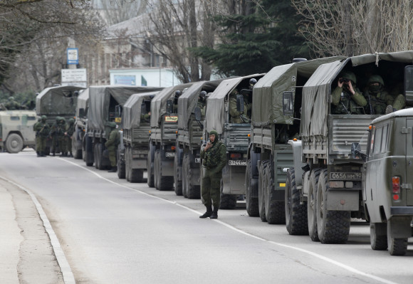 Armed servicemen wait in Russian army vehicles in the Crimean town of Balaclava
